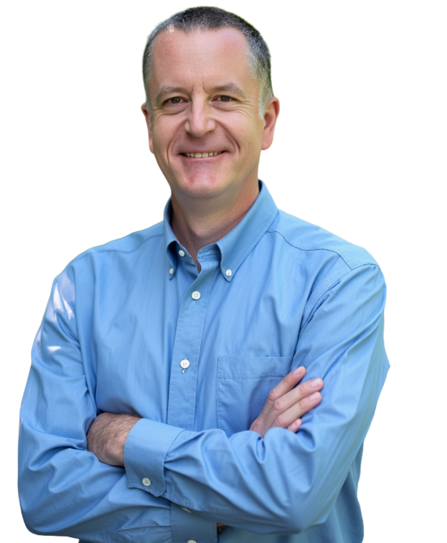 New England HR Consultant David Watts, a middle aged white man wearing a blue shirt smiling and crossing his arms.